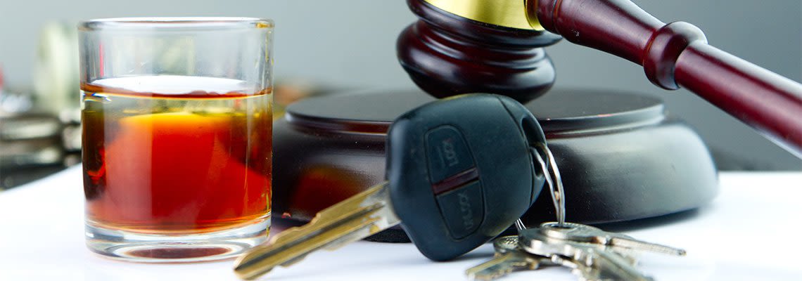 gavel and drink next to car keys