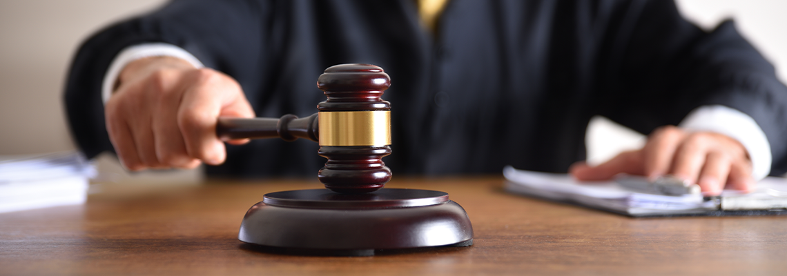 Judge passing sentence by hitting with gavel closeup