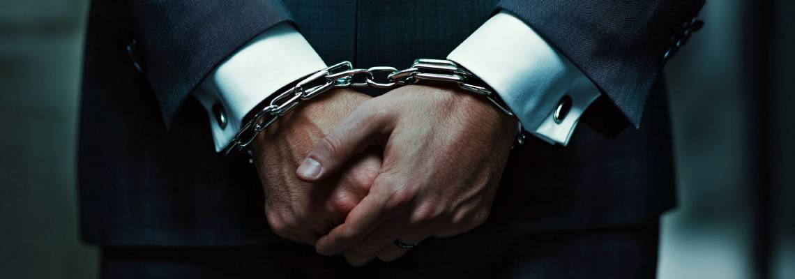 Handcuffed man in suit