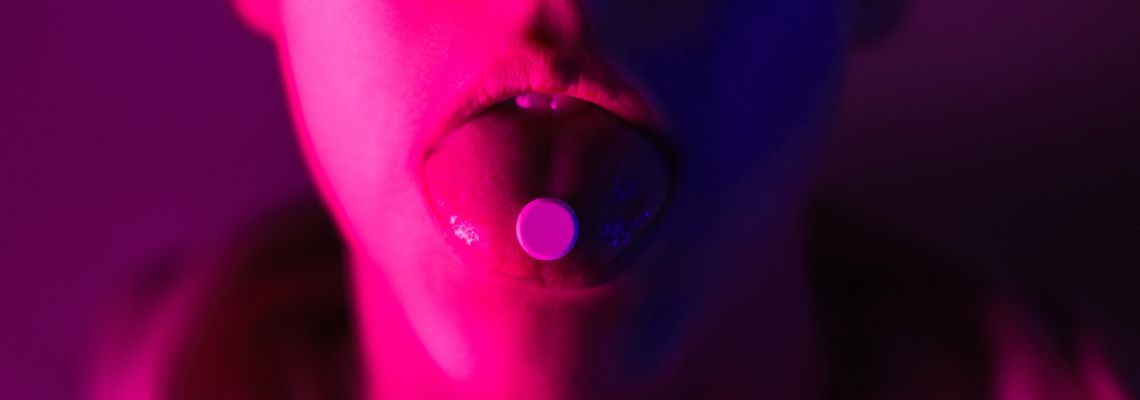 Young teenager taking drug pill