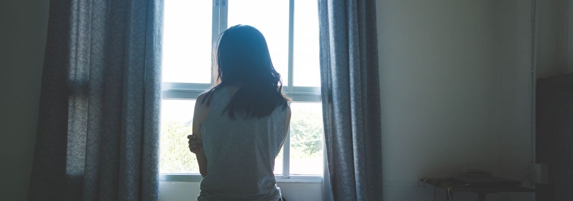 Abused women sitting in silence in dark room