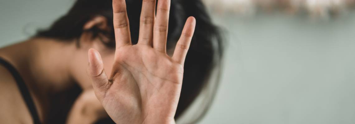 Women showing her hands gesturing to stop sexual violence