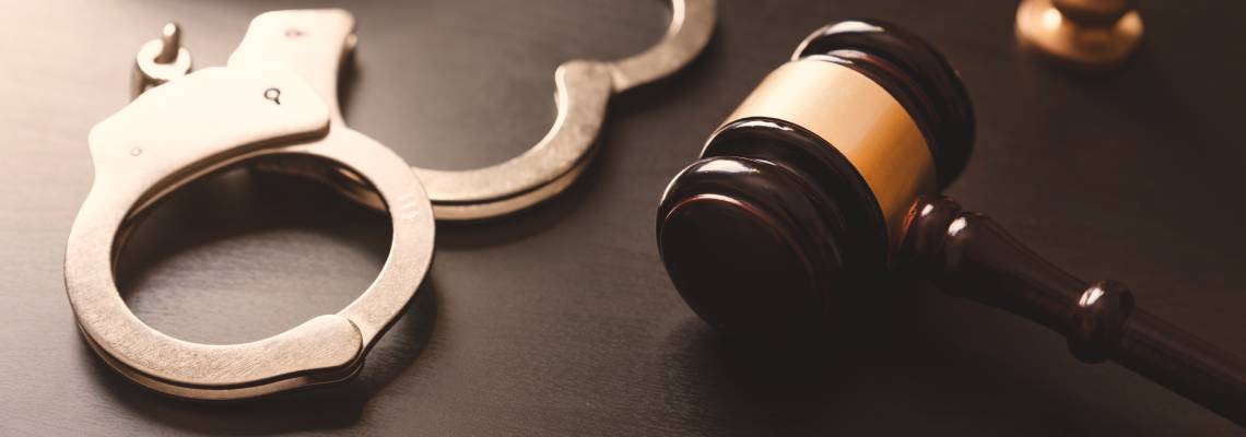 Gavel and handcuff in table