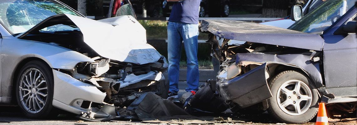Two totaled vehicles after head-on collision