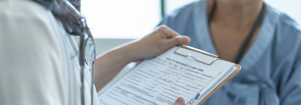 Doctor speaking with patient about insurance