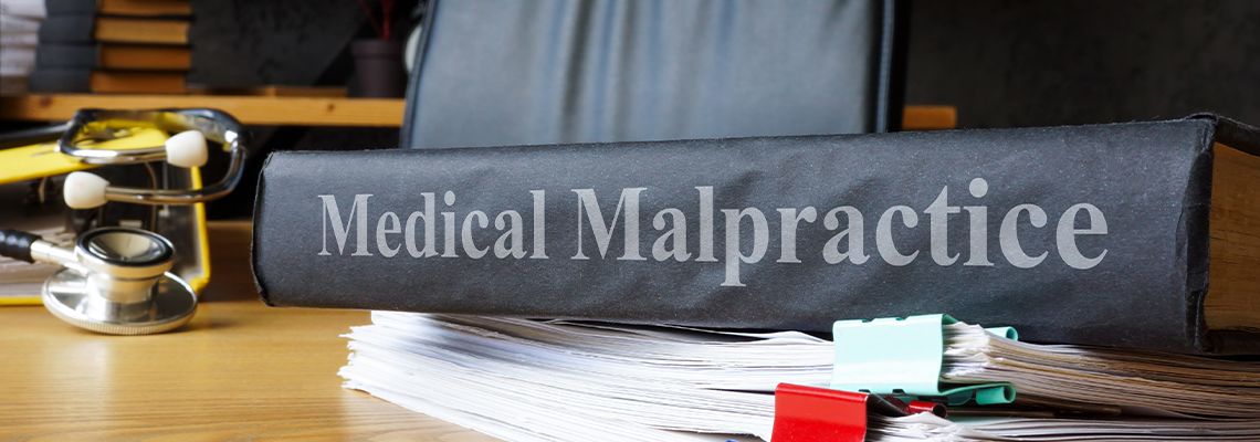 Medical malpractice documents on a table with stethoscope