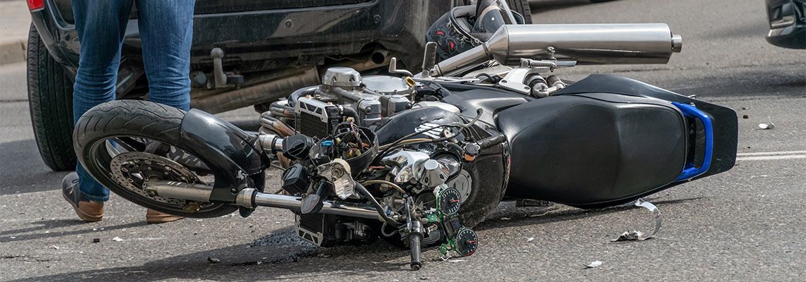 Damaged motorcycle after car accident