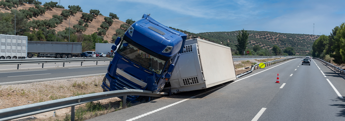 Truck with an accident refrigerated semi-trailer, overturned on road