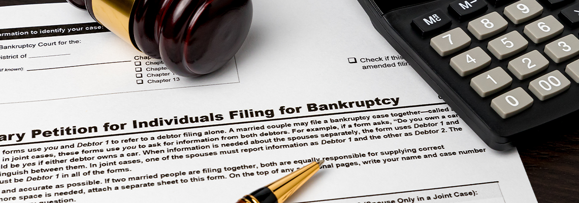 Bankruptcy petition for individuals with calculator and gavel