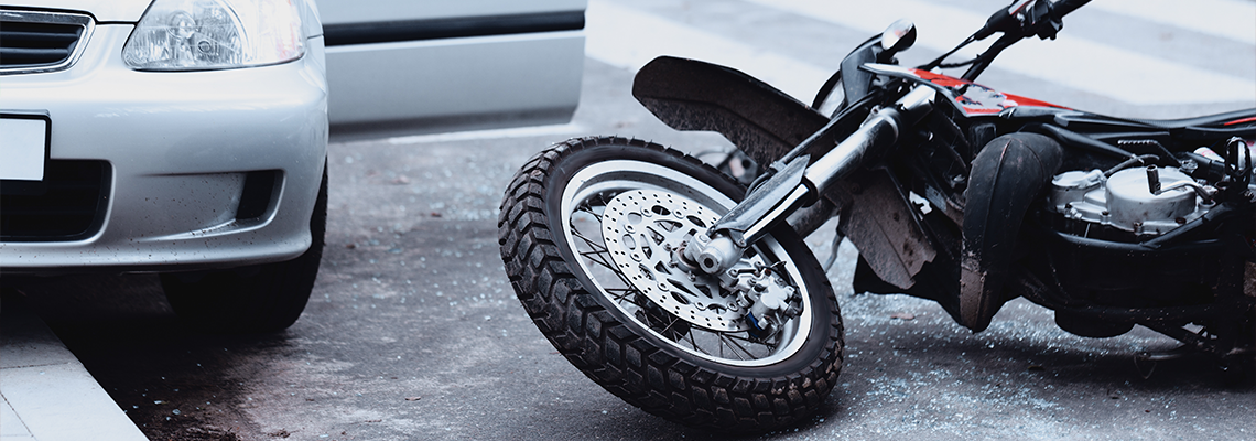 Motorcycle accident in front of a car