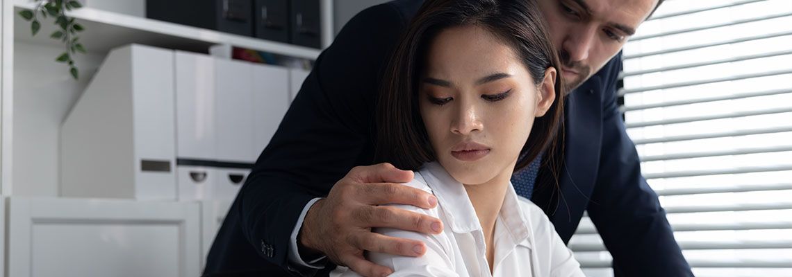 Man Molesting his Female Colleague by Touching her Shoulder