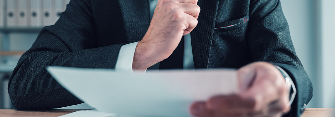 Fiduciary, agent carefully reading business papers in office