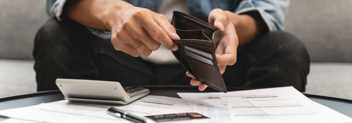 Man with empty wallet at home