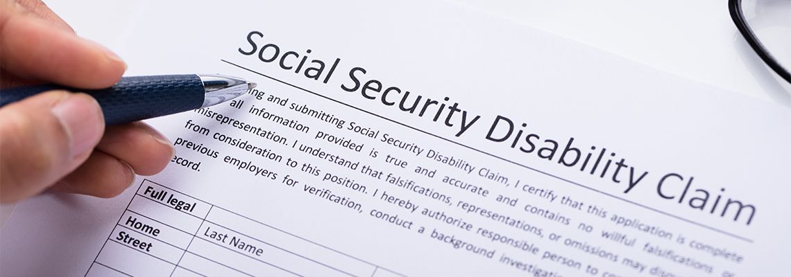 Person Filling Social Security Disability Claim Form
