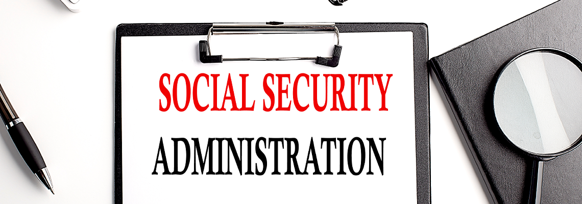Social Security Administration text written on paper clipboard with office tools