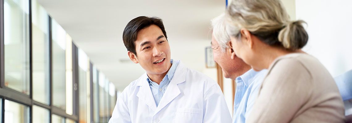 Senior couples consulting with doctor