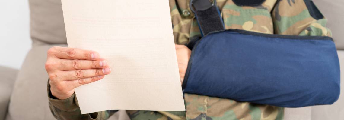 Injured veteran reading compensation letter