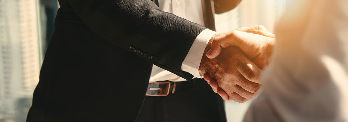 Businessmen shake hands after reaching an agreement