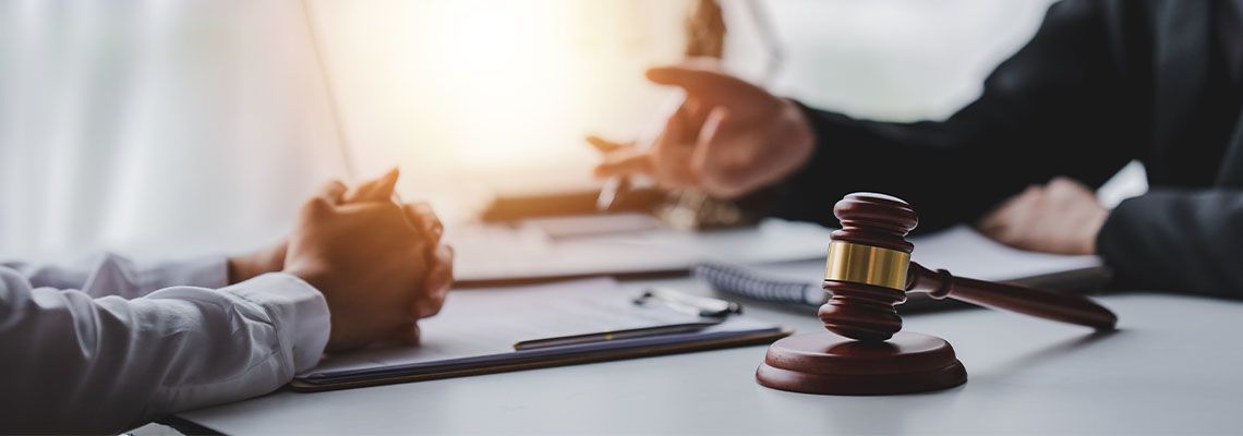 A male judge in the courtroom on a wooden table with client