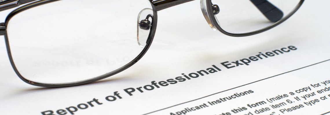 Glasses on a paper that says Report of Professional Experience