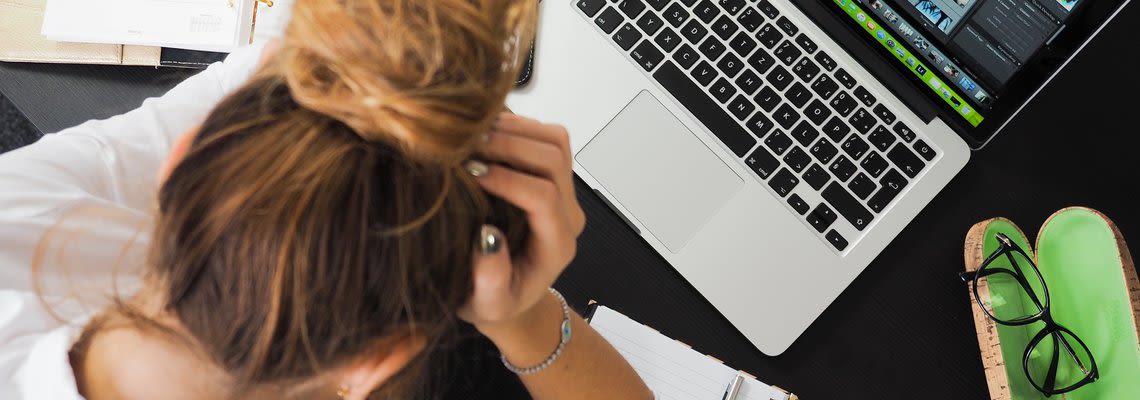 Stressed out woman at a computer