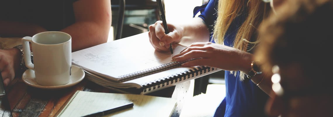 Woman writing in notebook