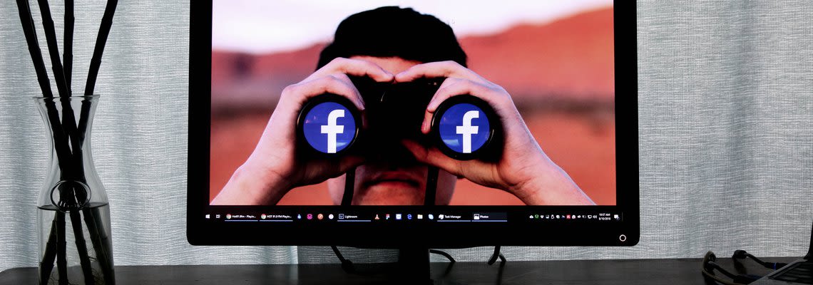 Binoculars looking at facebook