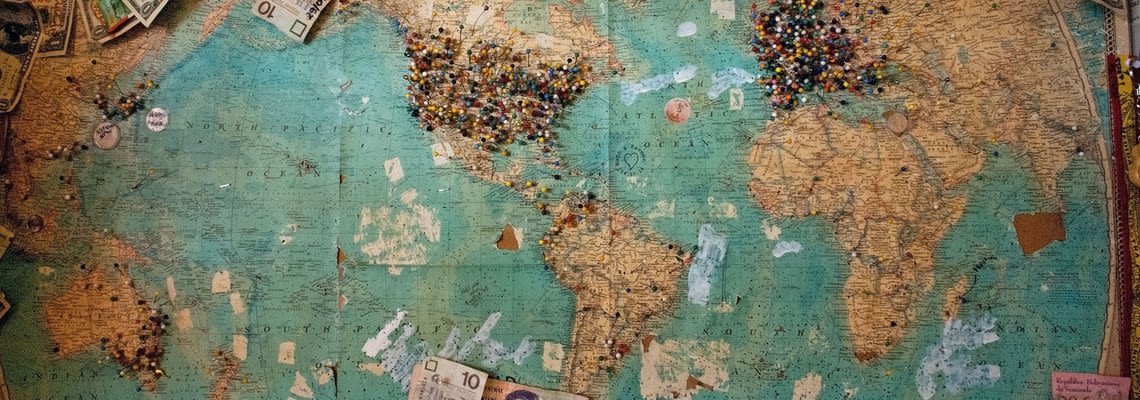 world map with pins all over