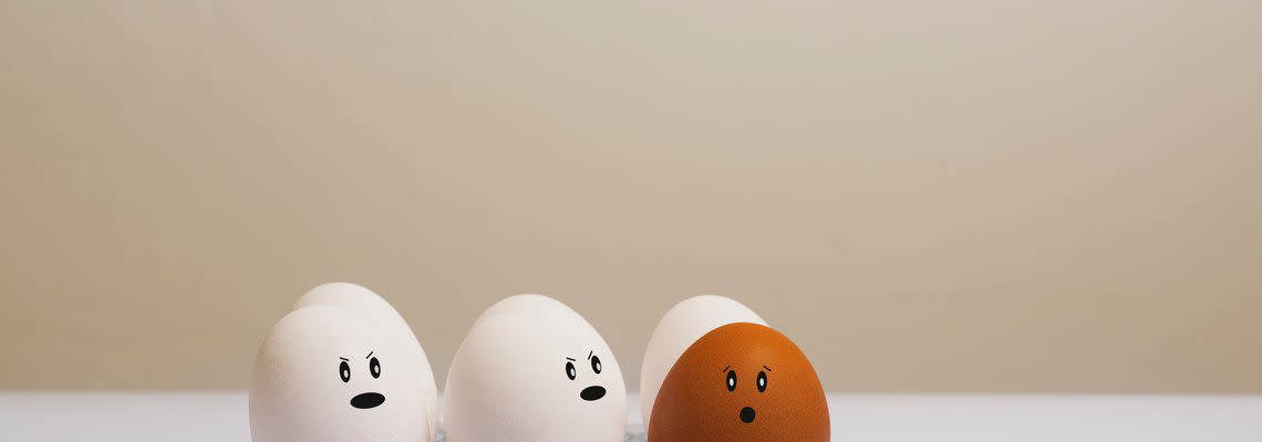 two white eggs mad at a brown egg
