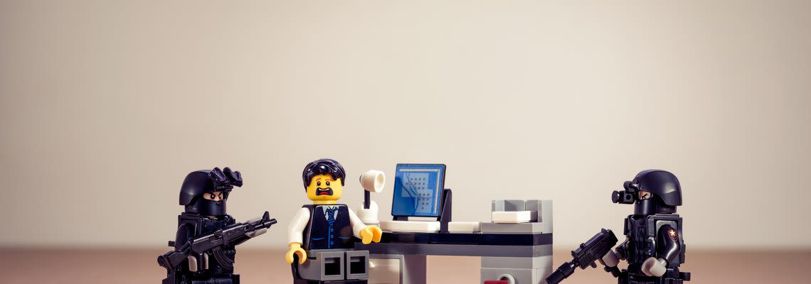 stressed lego figure being raided by police legos