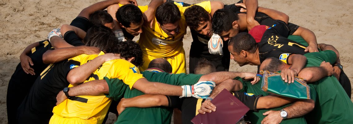 team of men in a huddle