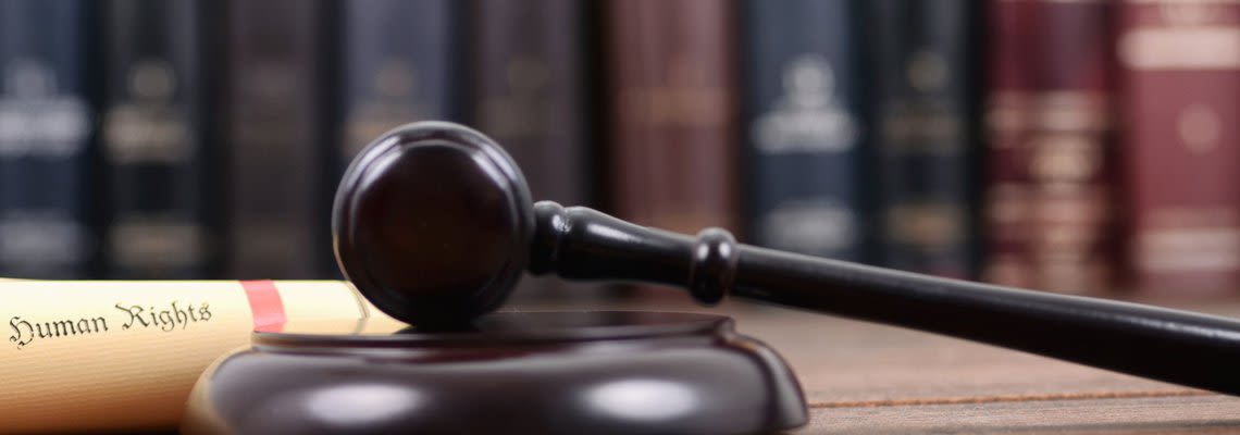 Gavel next to a human rights scroll