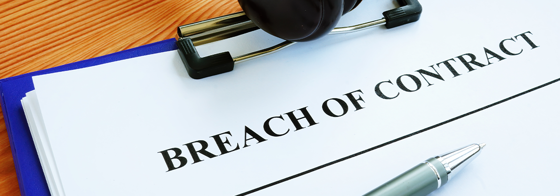 Clipboard with paperwork titled Breach of Contract