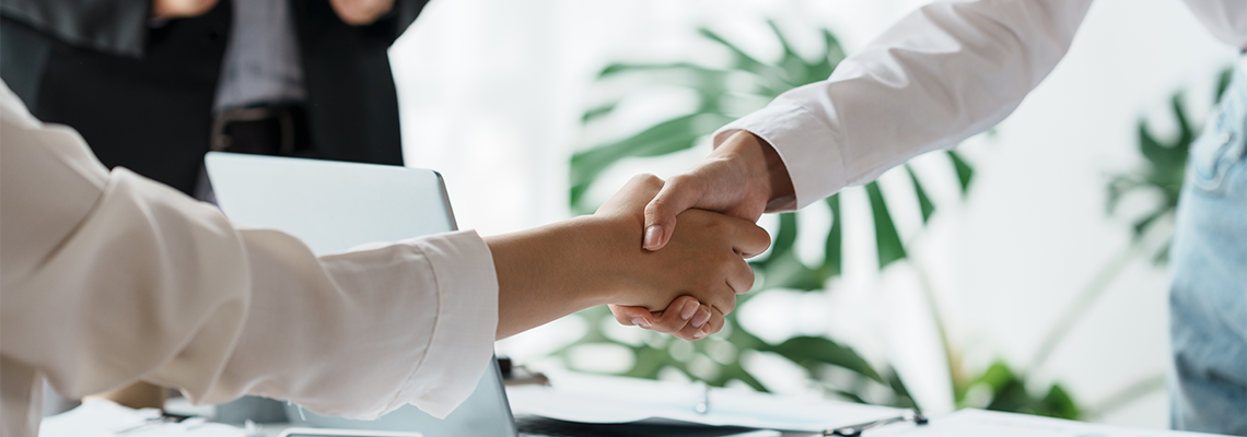 People shaking hands at the end of a meeting.