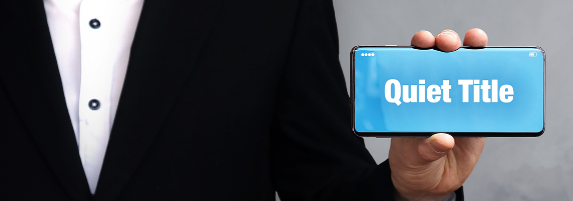 Man Shows Phone with Word 'quiet Title' in Display
