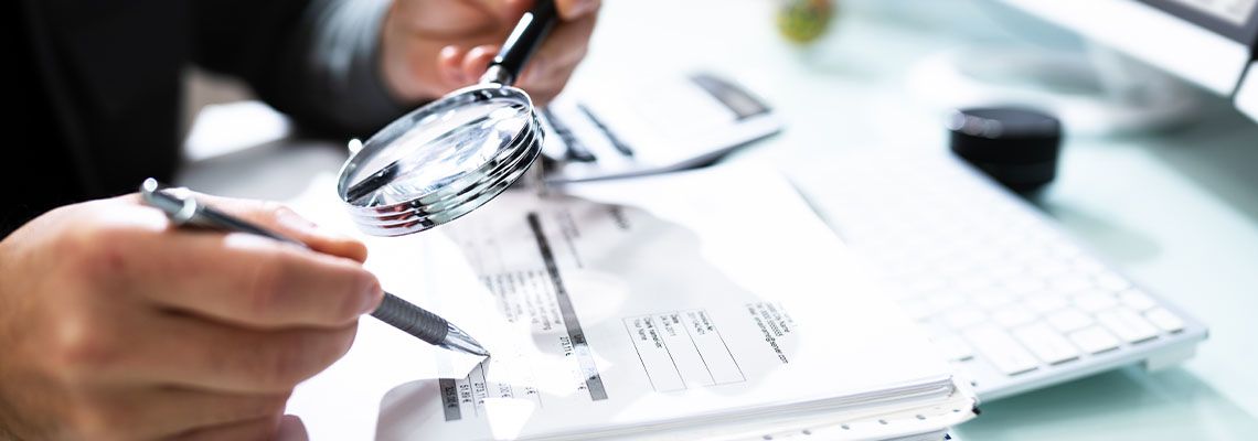 Auditor Using Magnifying Glass to Investigate Fraud