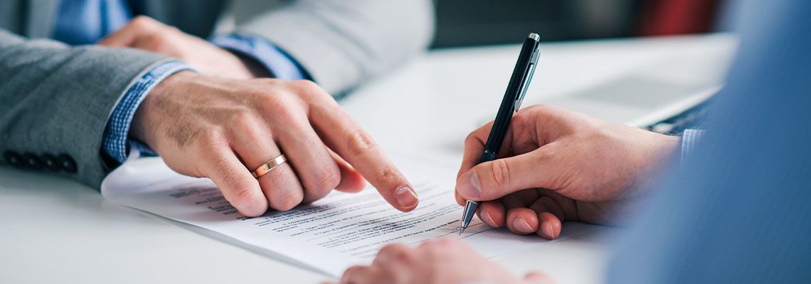 Boss pointing where to sign an employment contract
