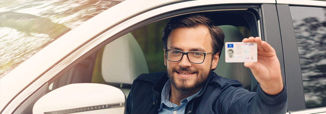 Young Happy Man Showing His New Driver License