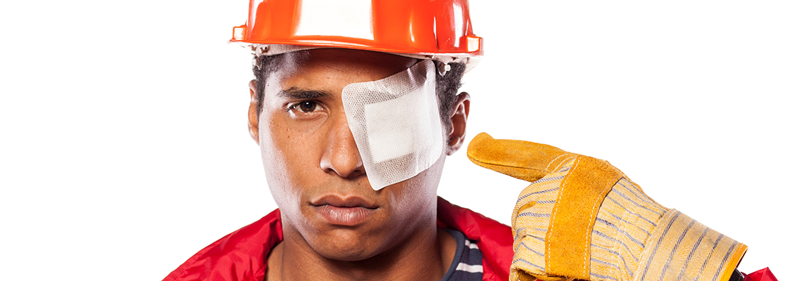 Sad dark-skinned worker with helmet and injured eye