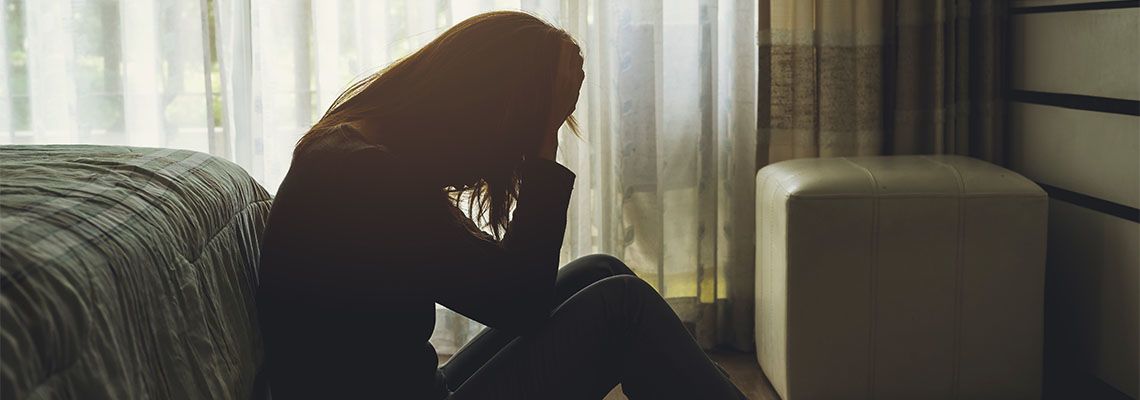 Emotionally distressed women sitting in floor