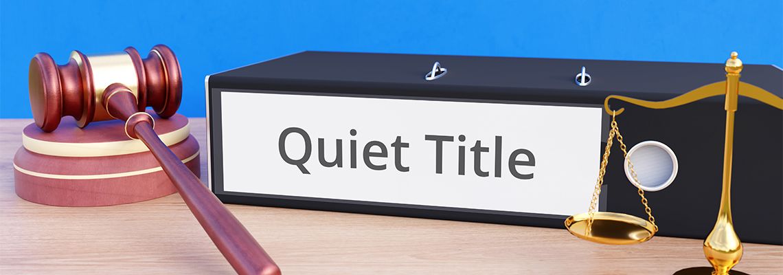 Quiet Title labelled folder along with gavel and scale of justice