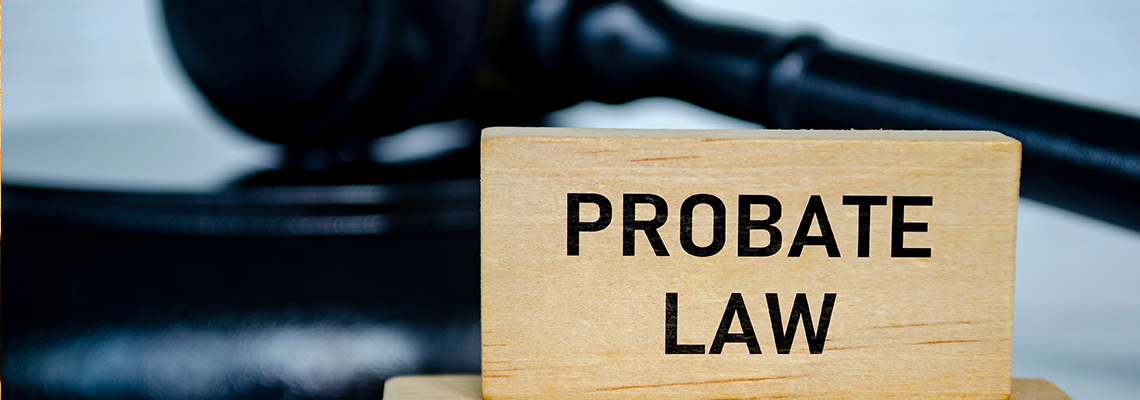 Probate Law text on wooden block with blurred lawyer gavel background