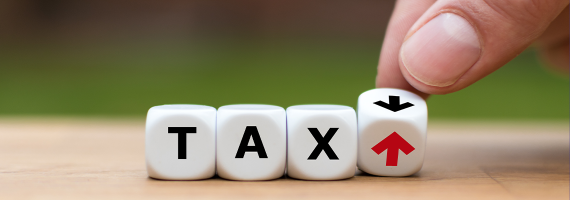 Dice and changes the direction of an arrow symbolizing that the Tax rate goes up (or down)