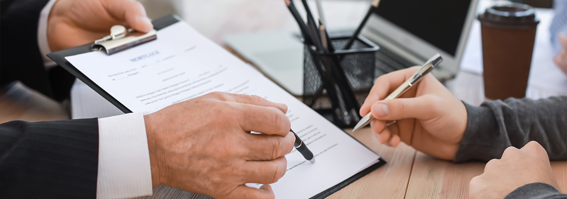 Man signing documents about inheritance of property