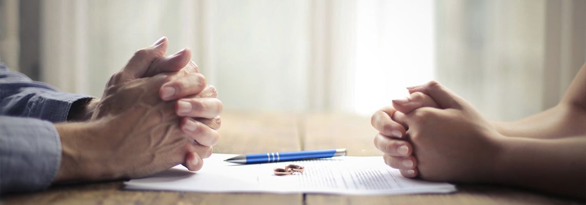 Two people signing divorce papers