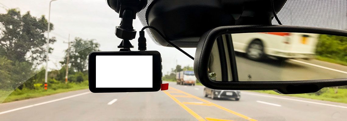 Black digital dashcam camera installed in the car