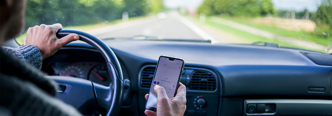 A Man Use Smartphone While Driving in The Car