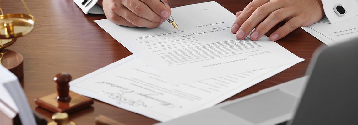 Lawyer in office signing document