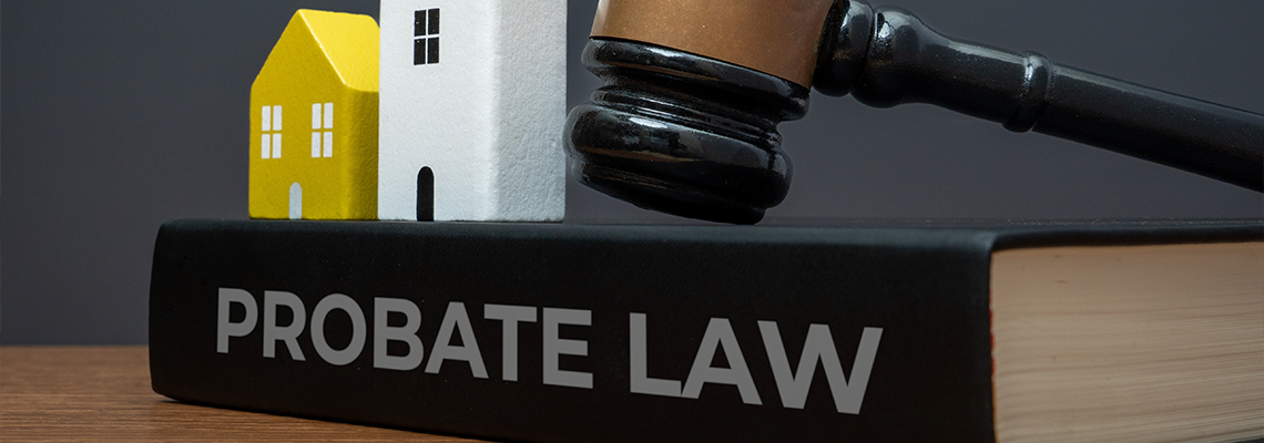 Miniature houses, judge's gavel and a PROBATE LAW book