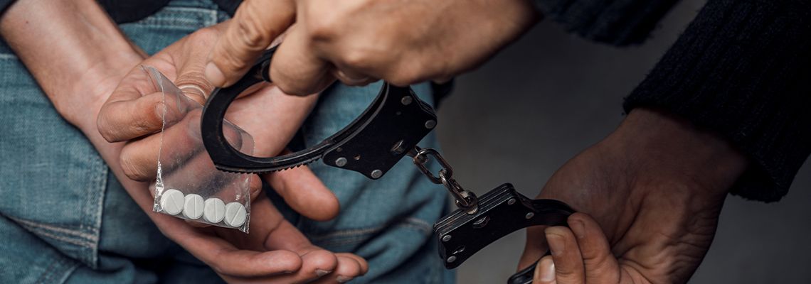 Police officer arresting man for drug possession